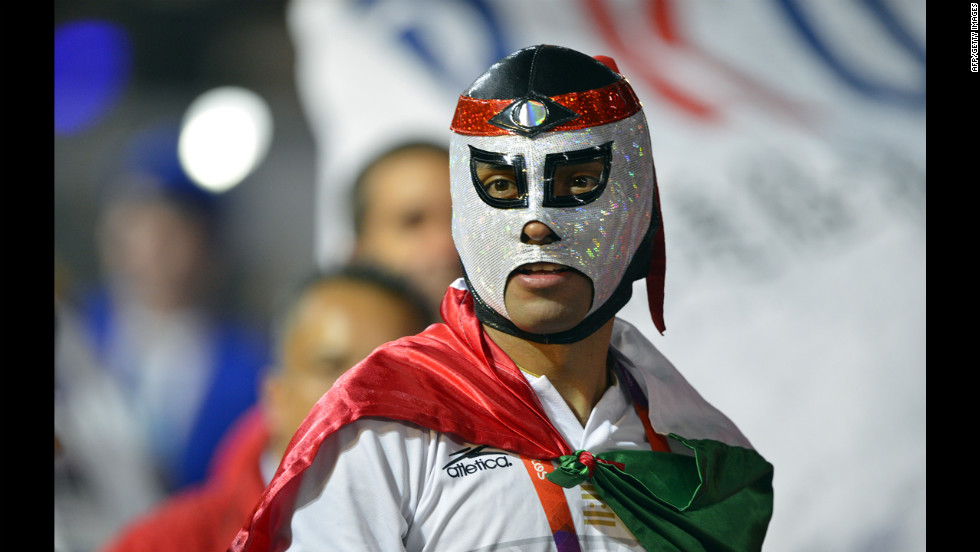 A Mexican athlete wearing a wrestler&#39;s mask parades during the closing ceremony.