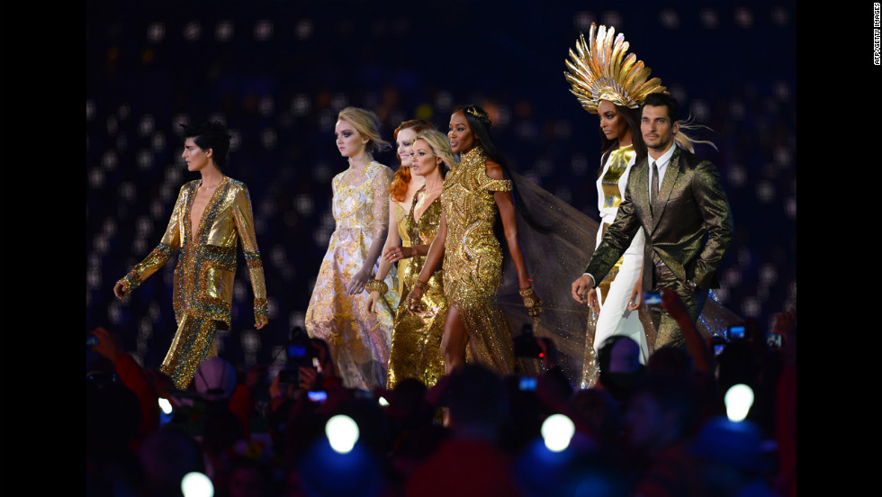 From left, British models Stella Tennant, Lily Cole, Karen Elson,  Kate Moss,  Naomi Campbell,  Jourdan Dunn and David Gandy perform at the Olympic stadium.