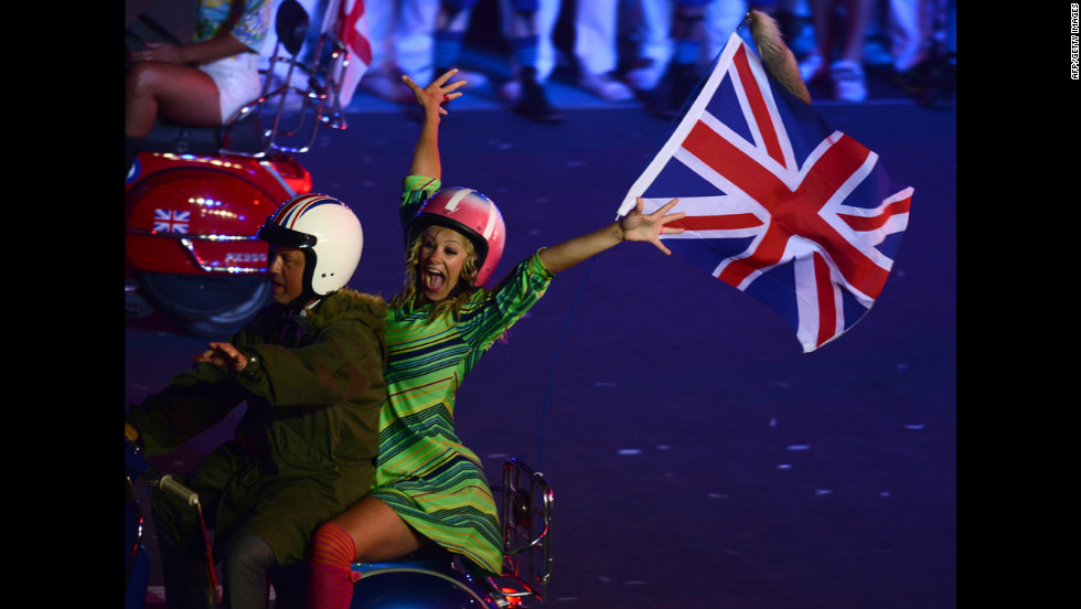 Actors ride scooters during the closing ceremony.