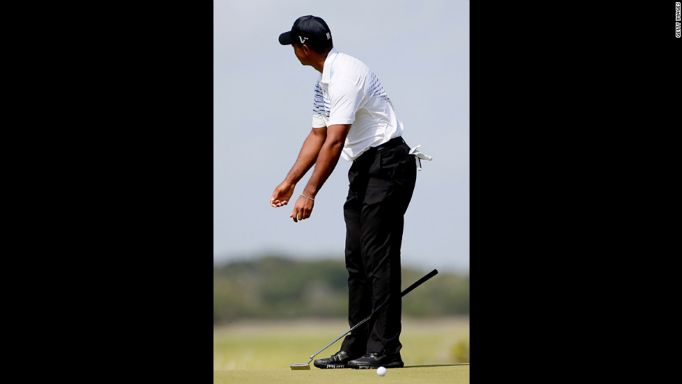 Woods, who dropped significantly in position Saturday, reacts after a missed putt on the fourth green.