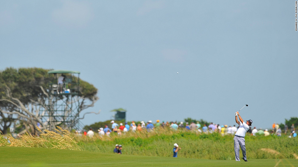 Phil Mickelson tries for the green from the fairway on the 7th hole.