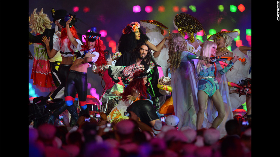 British comedian Russell Brand, center, performs at the Olympic stadium.