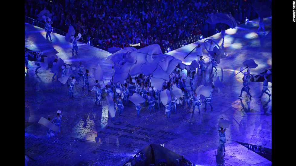 Artists form a sculpture representing the face of John Lennon during the closing ceremony.