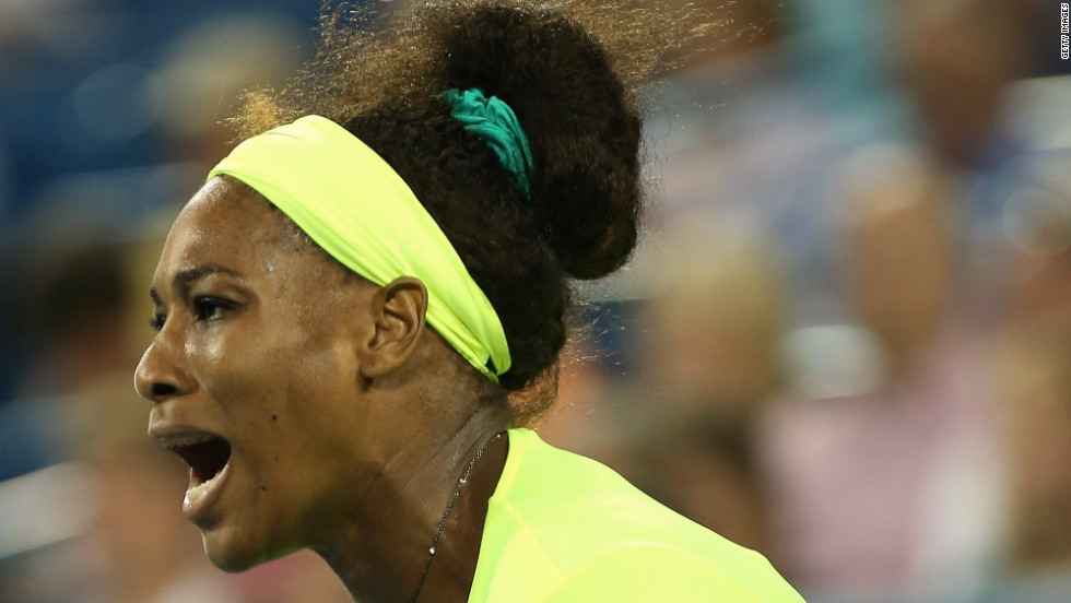 In a neon yellow outfit, Serena celebrates against Eleni Daniilidou of Greece during the 2012 Western &amp;amp; Southern Open in Mason, Ohio.