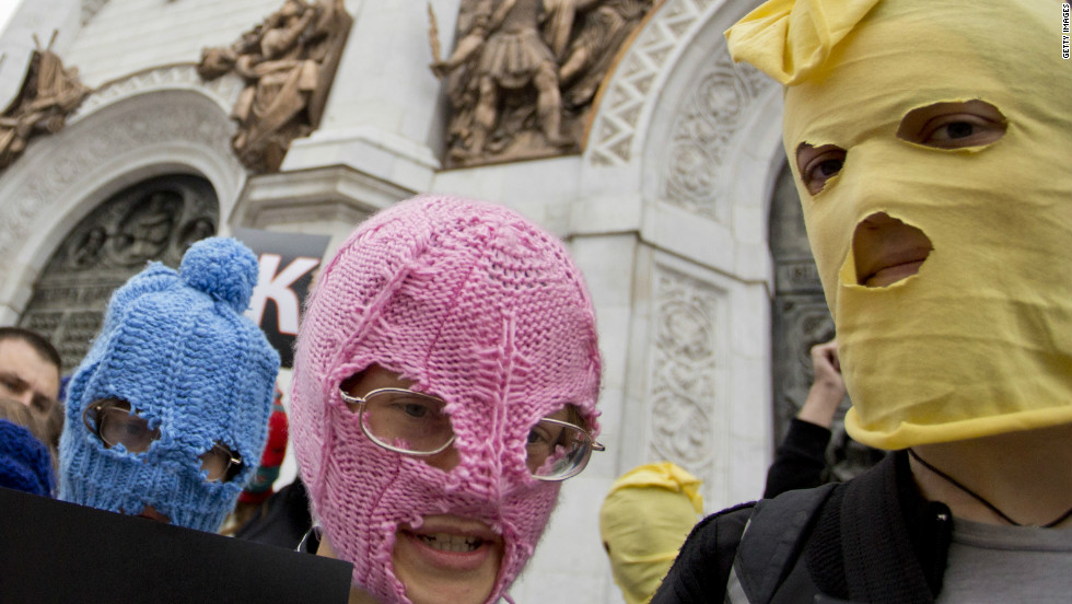 Campaigners wear the band&#39;s trademark colorful balaclavas in a demonstration outside the Church of Christ the Savior in Moscow.