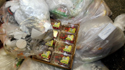 Boxes of strawberries sit amongst bags of trash found by &#39;Freegans&#39; outside of a grocery store 11 December, 2007 in New York. Just a few blocks from Manhattan&#39;s Fifth Avenue, bustling with Christmas shoppers, another group of New Yorkers are out getting what they need with one big difference, by not spending any money. For the city&#39;s &#39;Freegans,&#39; finding bell peppers, apples and bagels in the bags of trash that litter the city&#39;s sidewalks is a way of life. It is a winter evening in Manhattan&#39;s Midtown business district and a group of the anti-consumer activists meet up outside a luxury grocery store, timing their run for after the store closes but before the garbage trucks arrive. AFP PHOTO/DON EMMERT (Photo credit should read DON EMMERT/AFP/Getty Images)
