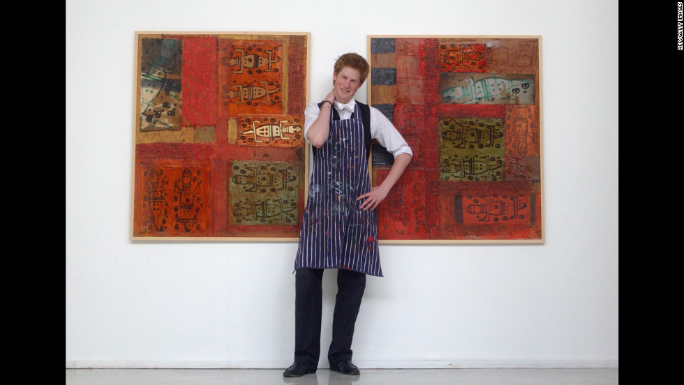 In 2003, Harry stands between some artwork he completed while studying at Eton College.
