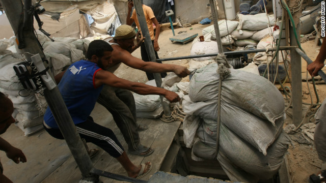 Palestinian workers in Gaza hoist goods out of a tunnel from the Egyptian side of the border last year