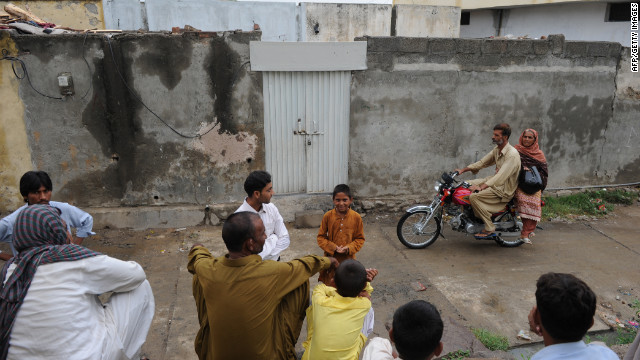 Pakistanis gather  in Islamabad, Pakistan, on August 22 outside the closed house of a Christian girl accused of blasphemy.