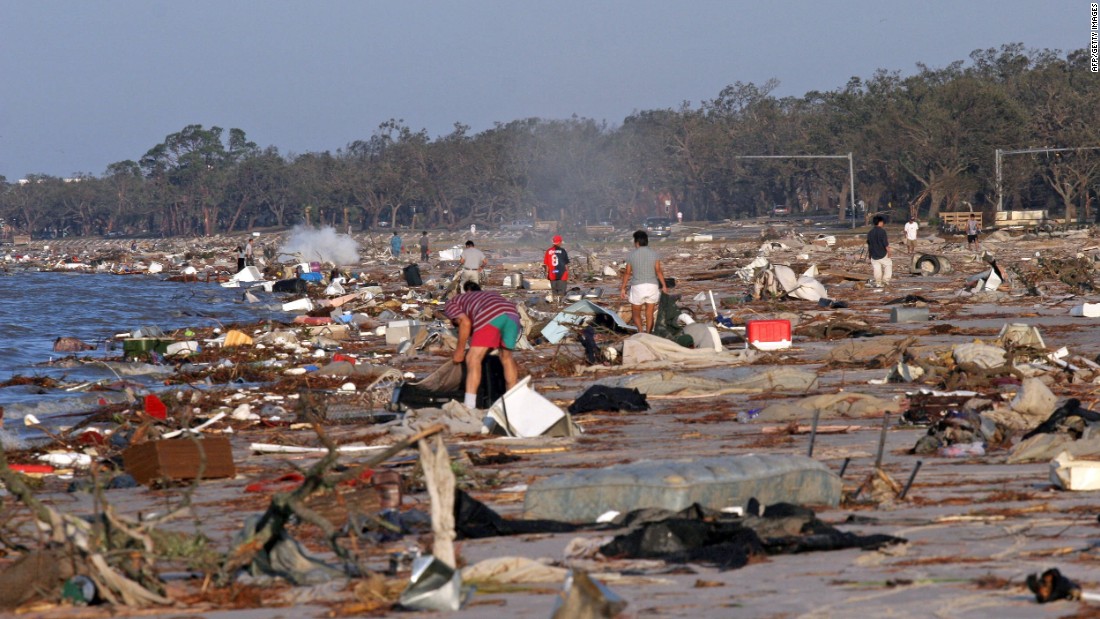 People search for their belongings among debris washed up on the beach in Biloxi on August 30, 2005.