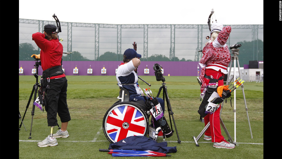 Britain&#39;s Mel Clarke, center, competes in the women&#39;s archery individual compound open ranking round.