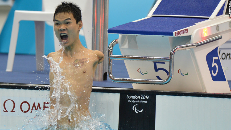 China&#39;s Zheng Tao celebrates breaking the world record after winning the men&#39;s 100-meter backstroke swimming event.