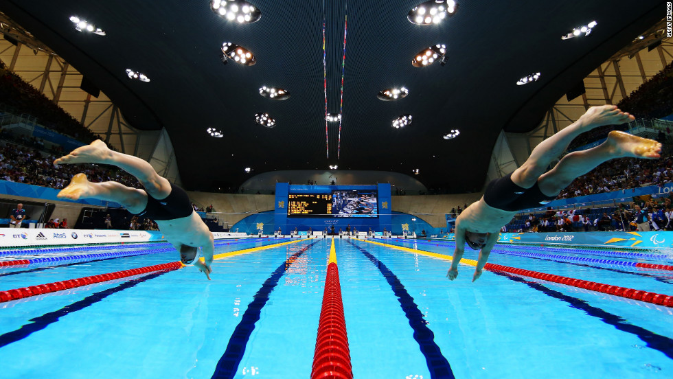 Daniel Fox, left, of Australia and Marc Evers of the Netherlands dive into the pool at the start of the men&#39;s 200-meter freestyle - S14 heat 3.