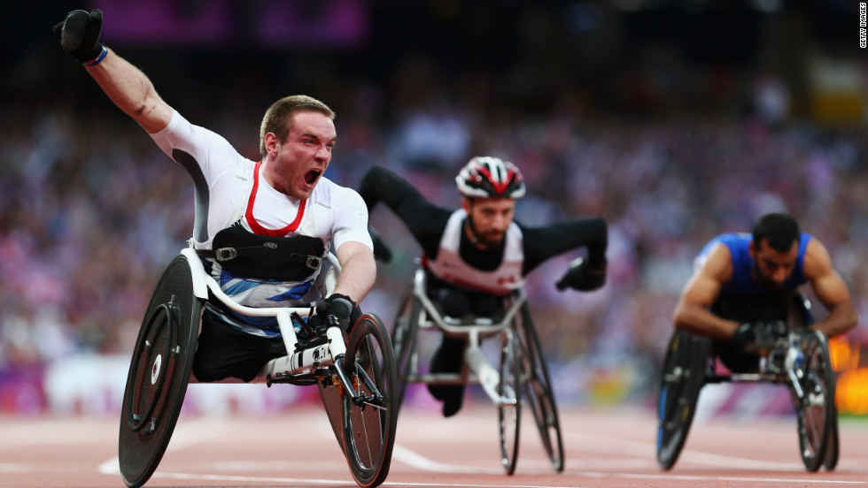 Mickey Bushell of Great Britain crosses the line to win gold in the men&#39;s 100-meter final.