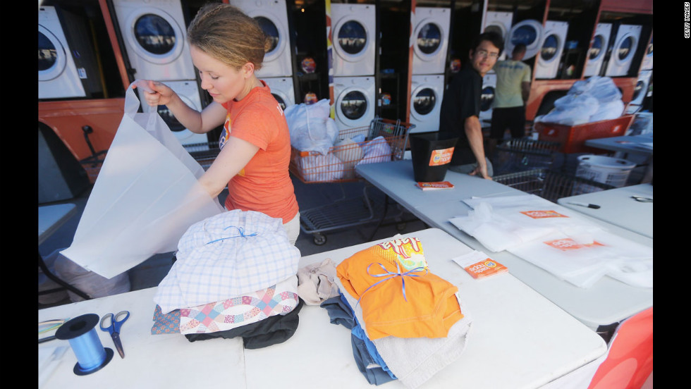 Worker Holly Rochelle sorts a resident&#39;s laundry, washed for free at the Tide Loads of Hope mobile laundromat set up for those affected by Isaac, on Thursday in LaPlace.