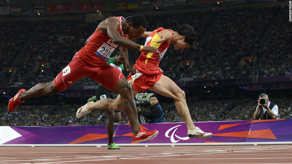 China&#39;s Zhao Xu, right, dips for the finish line, just ahead of Cuba&#39;s Raciel Gonzalez Isidoria to win the men&#39;s 100-meter T46 final on Thursday, September 6.