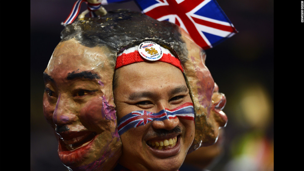 A spectator from Thailand wears masks as he watches Thursday&#39;s action at Olympic Stadium.