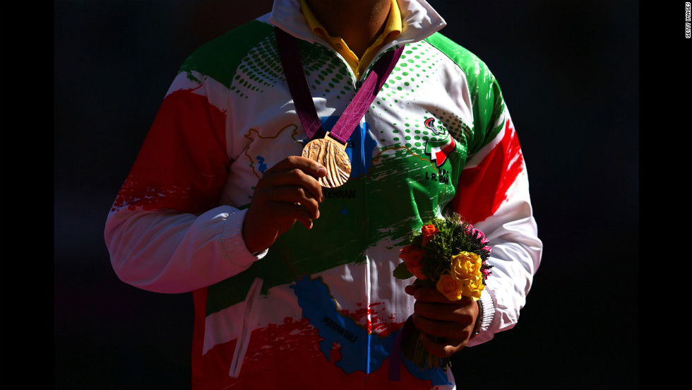 Bronze medalist Farzad Sepahvand of Iran poses Friday during the medal ceremony for the men&#39;s discus throw F44 final. 