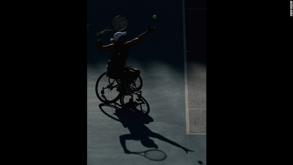 A shadow of Lucy Shuker serving with partner (out of frame) Jordanne Whiley of Great Britain to Sakhorn Khanthasit and Ratana Techamaneewat of Thailand in the women&#39;s doubles bronze medal match for wheelchair tennis on Friday.