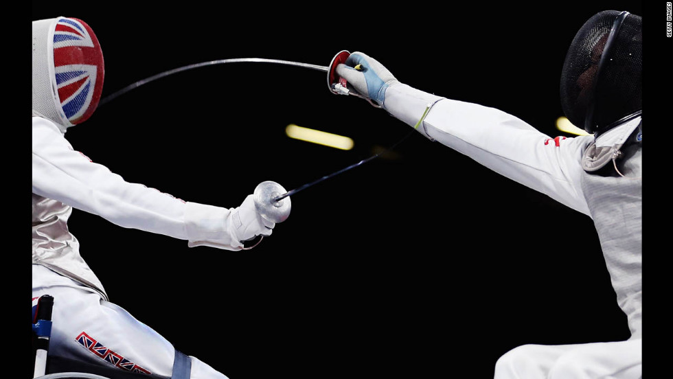Simon Wilson, left, of Great Britain competes against Tang Tat Wong of Hong Kong during the men&#39;s open wheelchair fencing quarter-final match on Saturday.