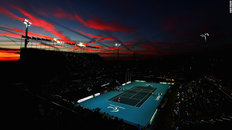 The sun sets as Shingo Kunieda of Japan, front left, plays against Stephane Houdet of France in the men&#39;s wheelchair tennis gold medal match on Saturday.