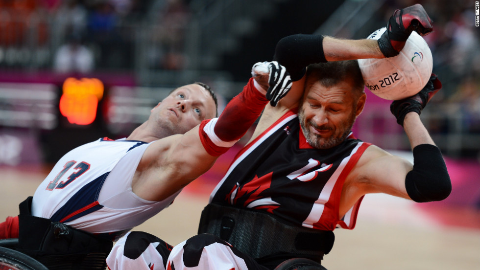 No. 13 Derrick Helton of the United States attempts to get the ball from No. 13 Jared Funk  of Canada during Saturday&#39;s mixed wheelchair rugby semifinal match between the U.S. and Canada.