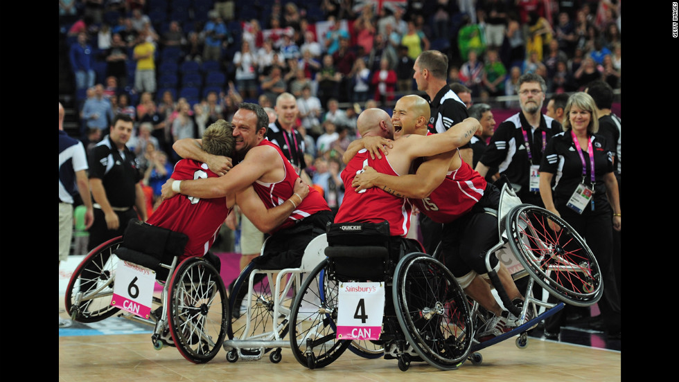 Canadian teammates celebrate after defeating Australia to win the gold medal wheelchair basketball competition Sunday.