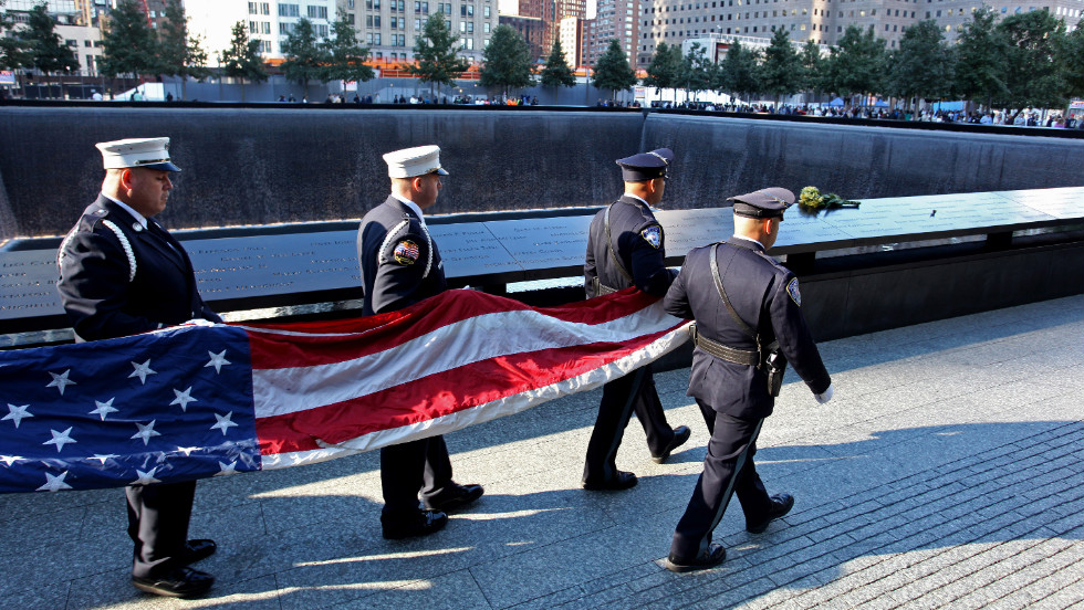 An honor guard carries an American flag Tuesday near the South Pool of the 9/11 Memorial.