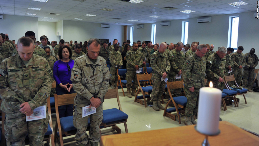 Soldiers with the NATO-led International Security Assistance Force pray during a memorial ceremony in Kabul, Afghanistan, on Tuesday, September 11.