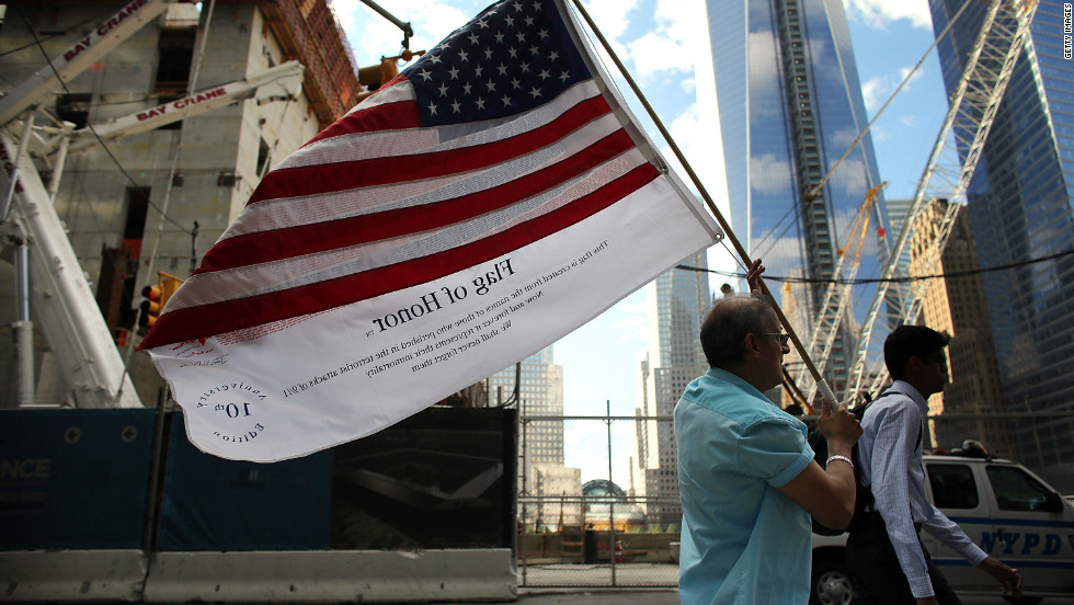 Germano Riviera carries the Flag of Honor, which displays the names of the victims of the September 11 attacks, across ground zero on Monday.