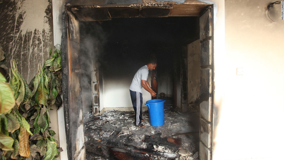 A man stands in part of a burned-out building of the U.S. mission on September 12. 