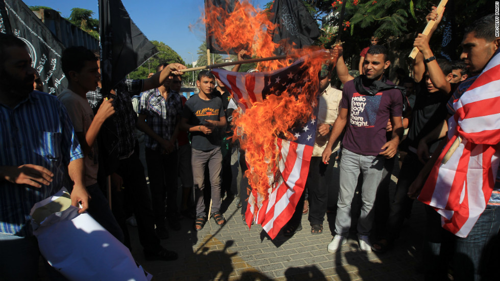 Palestinian men burn the American flag during Wednesday&#39;s demonstration in Gaza City.