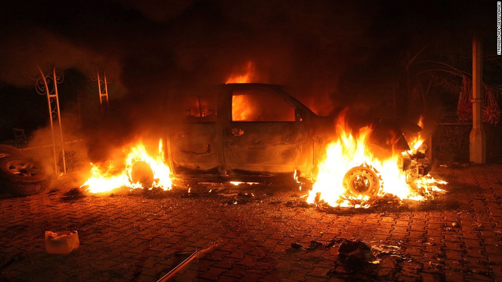 A vehicle and the surrounding area are engulfed in flames after it was set on fire inside the compound on Tuesday.