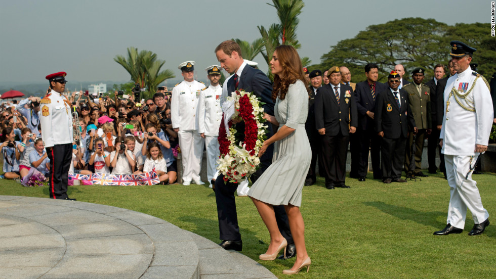 Britain&#39;s Prince William and his wife, Catherine, lay a wreath to pay their respects to WWII dead at the Kranji War Cemetery in Singapore Thursday.