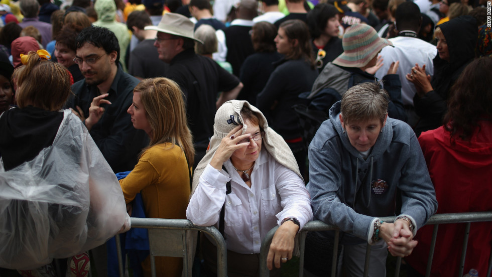 Supporters try to stay dry in between rain showers while waiting for President Obama to speak at the University of Iowa on Friday. It was Obama&#39;s first day of campaigning after accepting the presidential nomination at the Democratic National Convention in Charlotte, North Carolina.