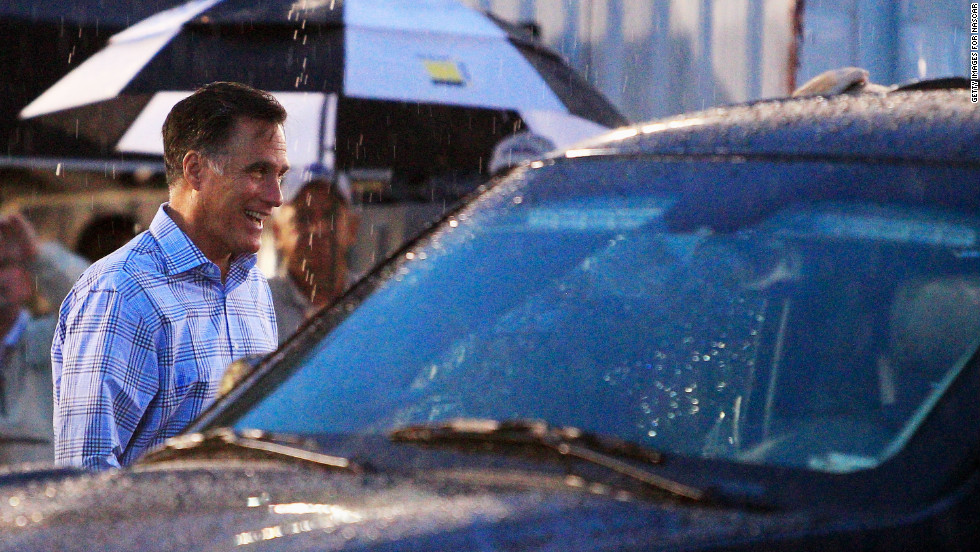 Mitt Romney walks through the garage area during a rain delay before the start of the NASCAR Sprint Cup Series Federated Auto Parts 400 at Richmond International Raceway on Saturday, September 8, in Richmond, Virginia.  