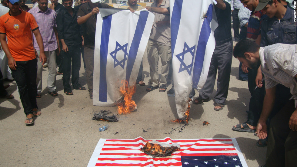 Iraqi protesters burn Israeli and U.S. flags during a protest Thursday.  The U.S. ambassador to Libya, J. Christopher Stevens, and three others were killed during a protest outside the U.S. Consulate in Benghazi, Libya, on Tuesday.