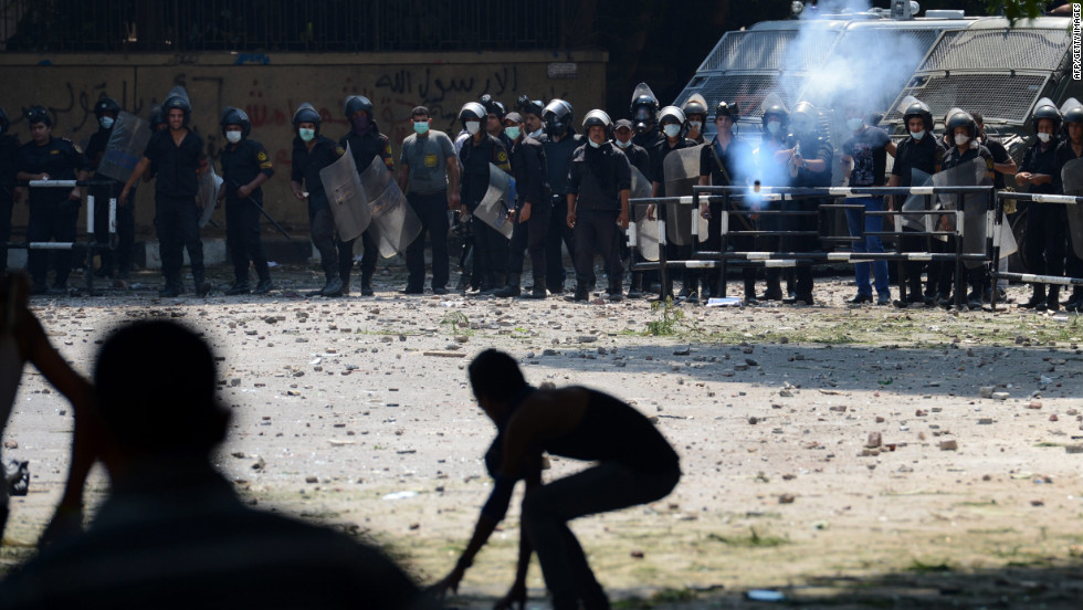 An Egyptian riot police officer fires tear gas toward protesters during clashes Thursday with police near the U.S. Embassy in Cairo. 