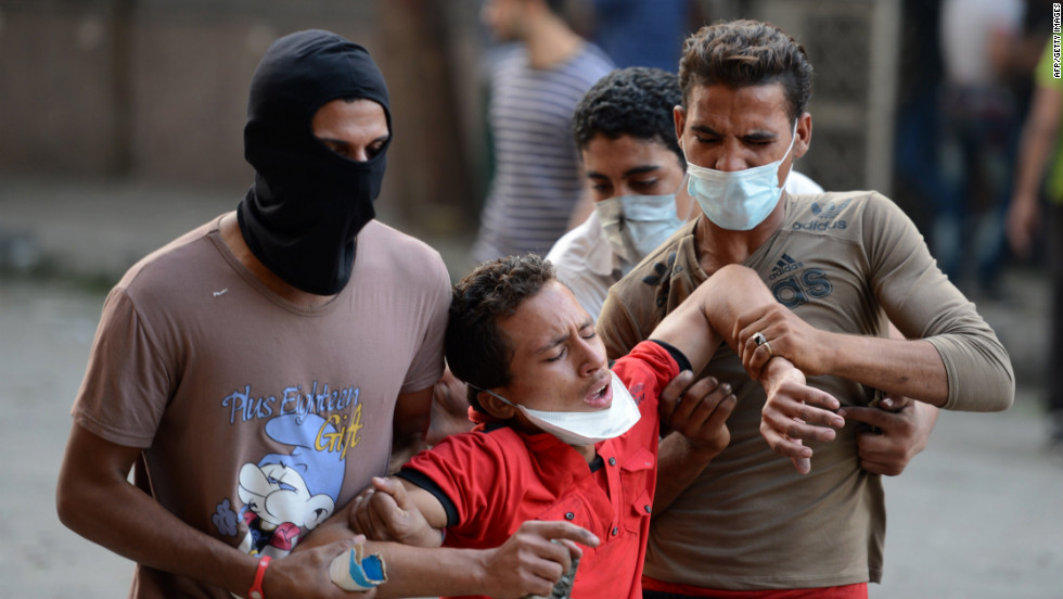 Egyptian protesters help a man who inhaled tear gas during clashes at the U.S. Embassy in Cairo on Thursday.