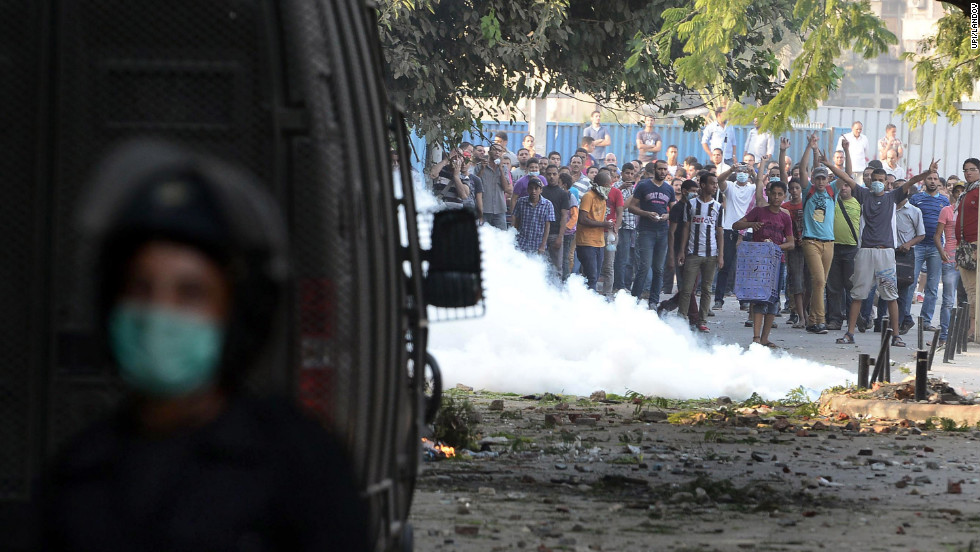 Egyptian protesters throw stones at riot police during clashes near the U.S. Embassy in Cairo on Thursday.