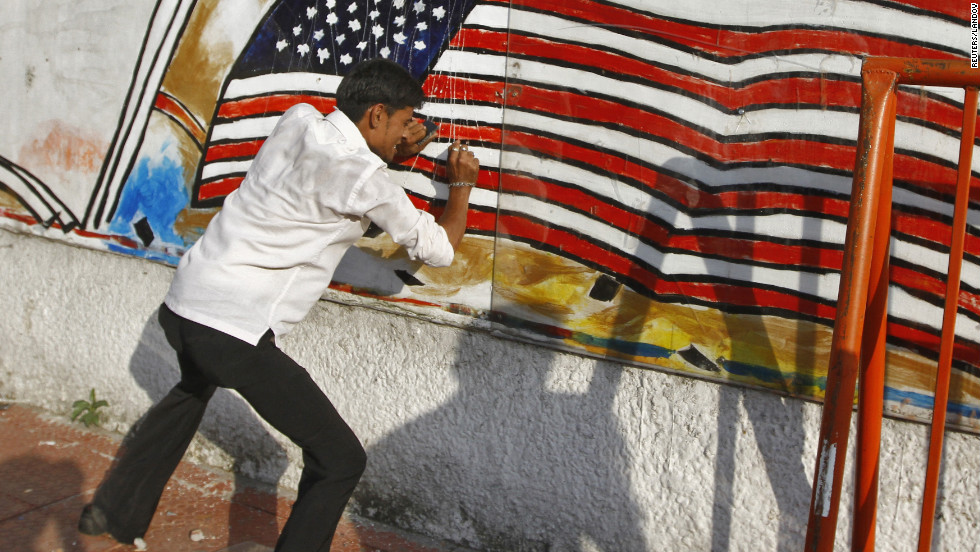 A Muslim protester defaces a mural on a wall of the U.S. Consulate in the southern Indian city of Chennai on Friday.