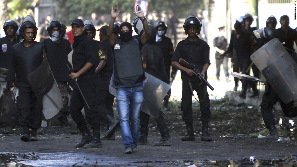 A riot police officer shouts a warning during clashes in Cairo on Friday. 