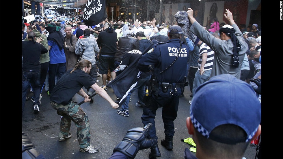 A protester hits a policeman with a pole in Sydney&#39;s central business district on Saturday, September 15. Anger over an anti-Islam video, &quot;The Innocence of Muslims,&quot; spread to Australia on Saturday, and protesters took to the streets of the country&#39;s capital.