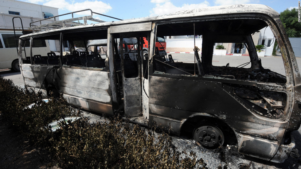 A burned bus sits in the grounds of the American school in Tunis on Saturday.