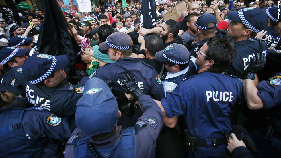 Protesters clash with police on a street in Sydney&#39;s central business district on Saturday.