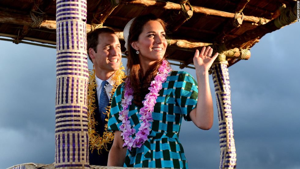 Britain&#39;s Prince William and his wife, Catherine, Duchess of Cambridge, wave to Solomon Islanders as they leave the airport aboard a truck decorated as a canoe in Honiara on Sunday.