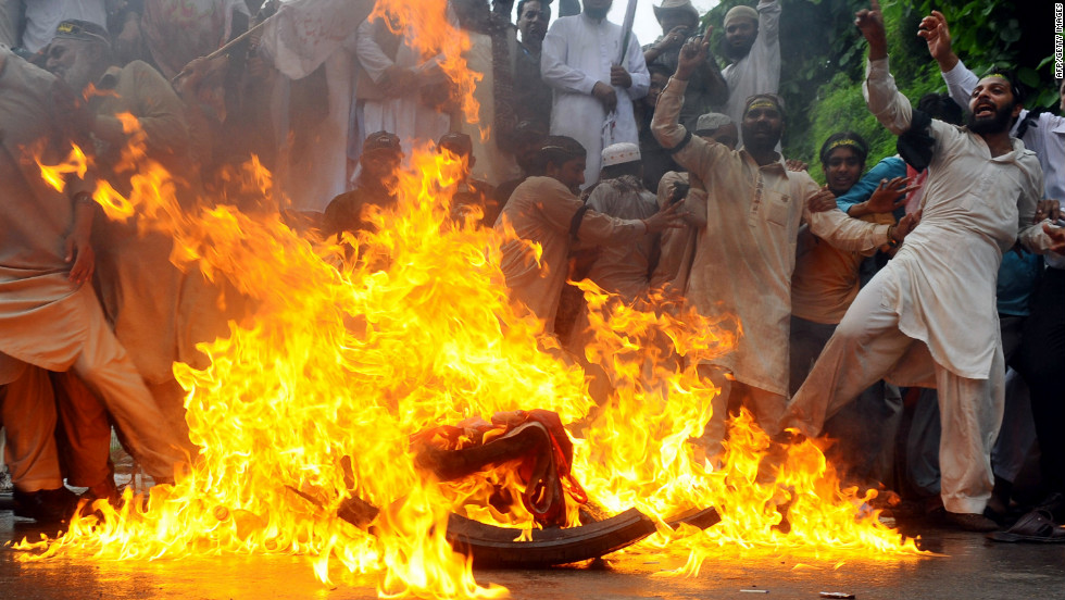 Sunni Muslims burn a U.S. flag during a protest in Lahore, Pakistan, on Monday. Protests entered their second week, with demonstrators taking to the streets in Pakistan, Afghanistan, Indonesia and Lebanon.