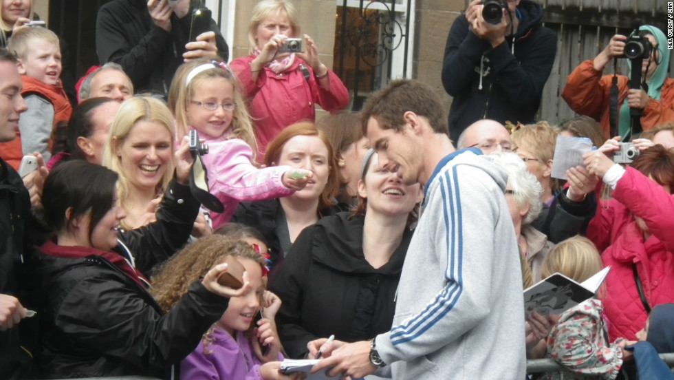 Murray, who beat Novak Djokovic in five sets to clinch his first grand slam title, spent four-and-a-half hours signing autographs and playing tennis with young fans at his former club.