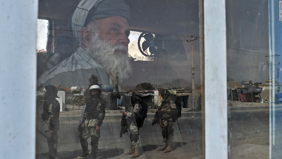 Afghan riot police are reflected through a window during an anti-U.S. protest Monday in Kabul, Afghanistan. Protesters attacked police along a road leading to the U.S. Embassy in Kabul.