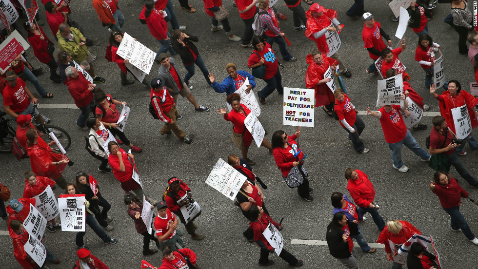 The protesters march down Michigan Avenue on Thursday. Vocal picketing has taken place in and around the city&#39;s schools.